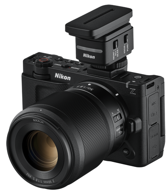 니콘 ZR 카메라에 니코르 Z 50mm f/1.8 S 렌즈와 전용 니콘 핫슈 무선 마이크가 장착된 모습. 상단의 REC 버튼과 모드 다이얼이 선명하게 보인다.